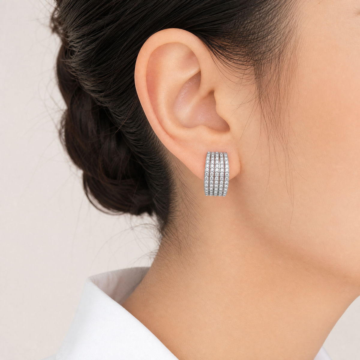 DEFT0698W model shot - five-row pave round diamond wide huggie hoop earring worn on ear