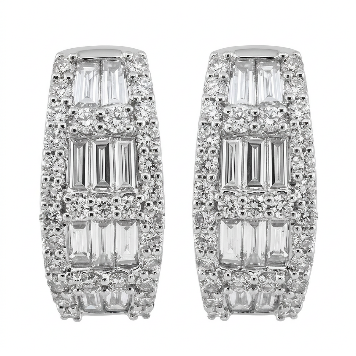 18K white gold baguette and round diamond huggie hoop earrings on a white background