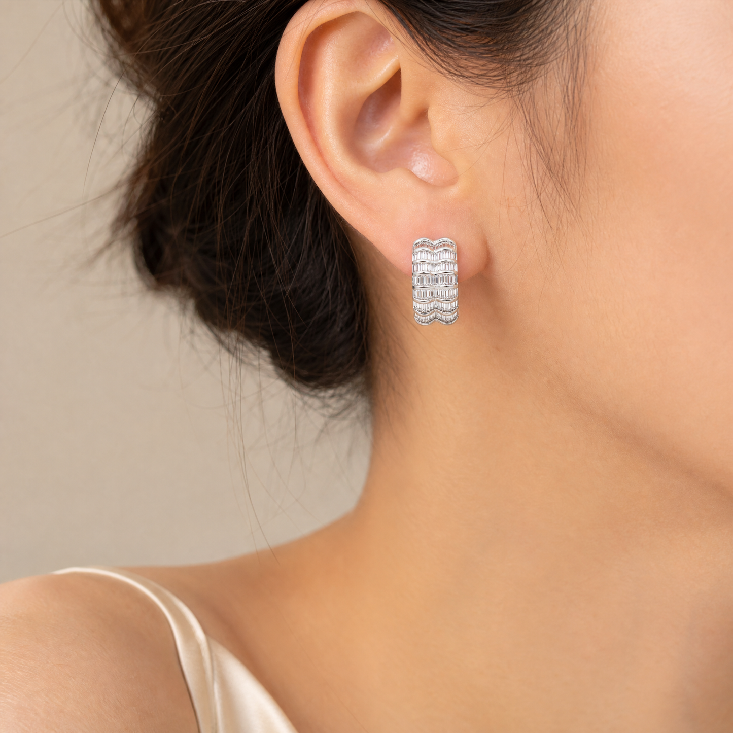 DEKS0431W model shot - tapered baguette diamond multi-row curved clip earring worn on ear