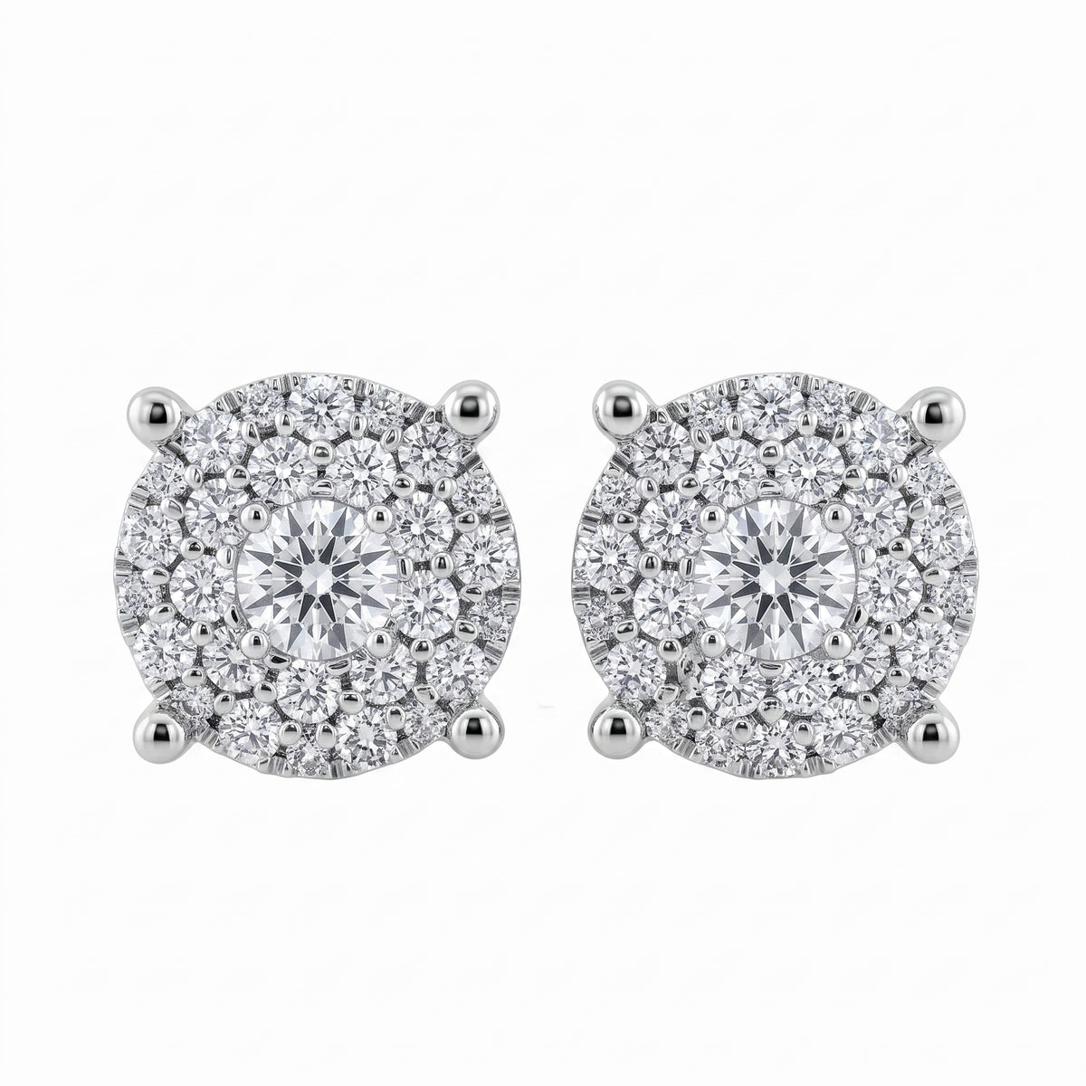 56-Diamond Round Stud Earrings, 7.5mm - 18K white gold round paved illusion cluster with one centre round brilliant, a ring of six medium round brilliants and outer rings of smaller round diamonds, four diagonal claw prongs