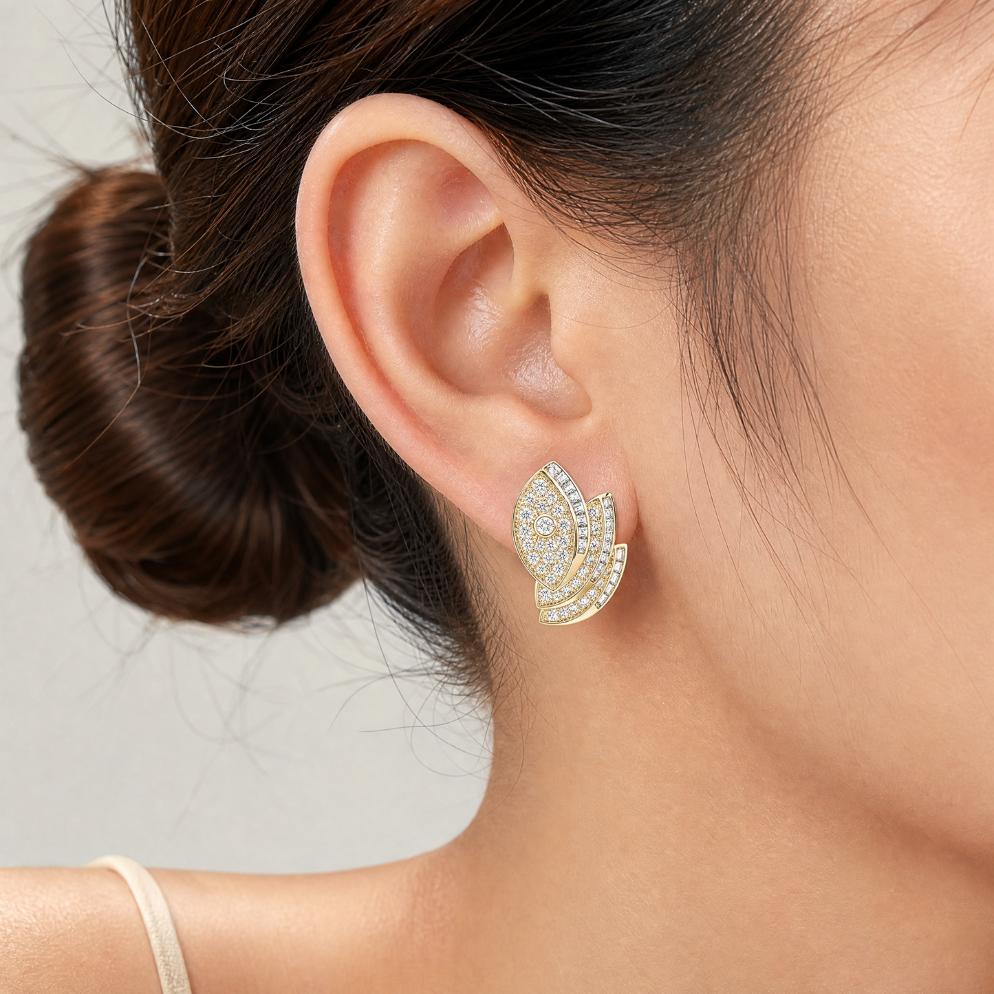 EDE47350 model shot - pave and channel-set diamond double leaf scroll clip earring worn on ear