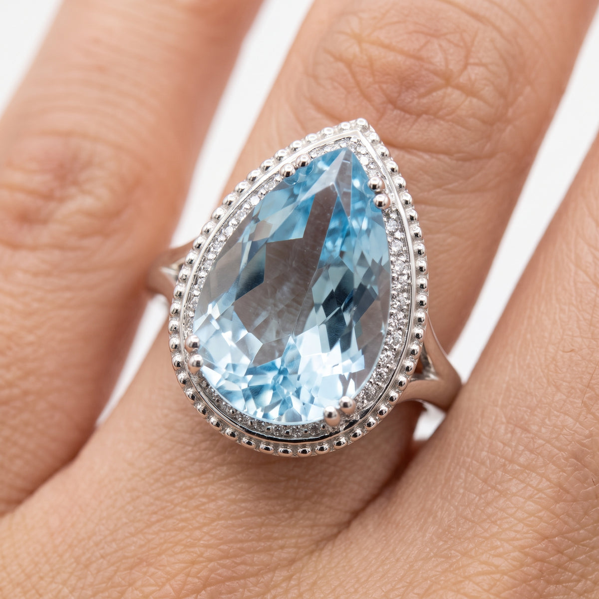 10x16mm Checkerboard-Cut Pear Sky Blue Topaz & 27-Diamond Rope Edge Ring