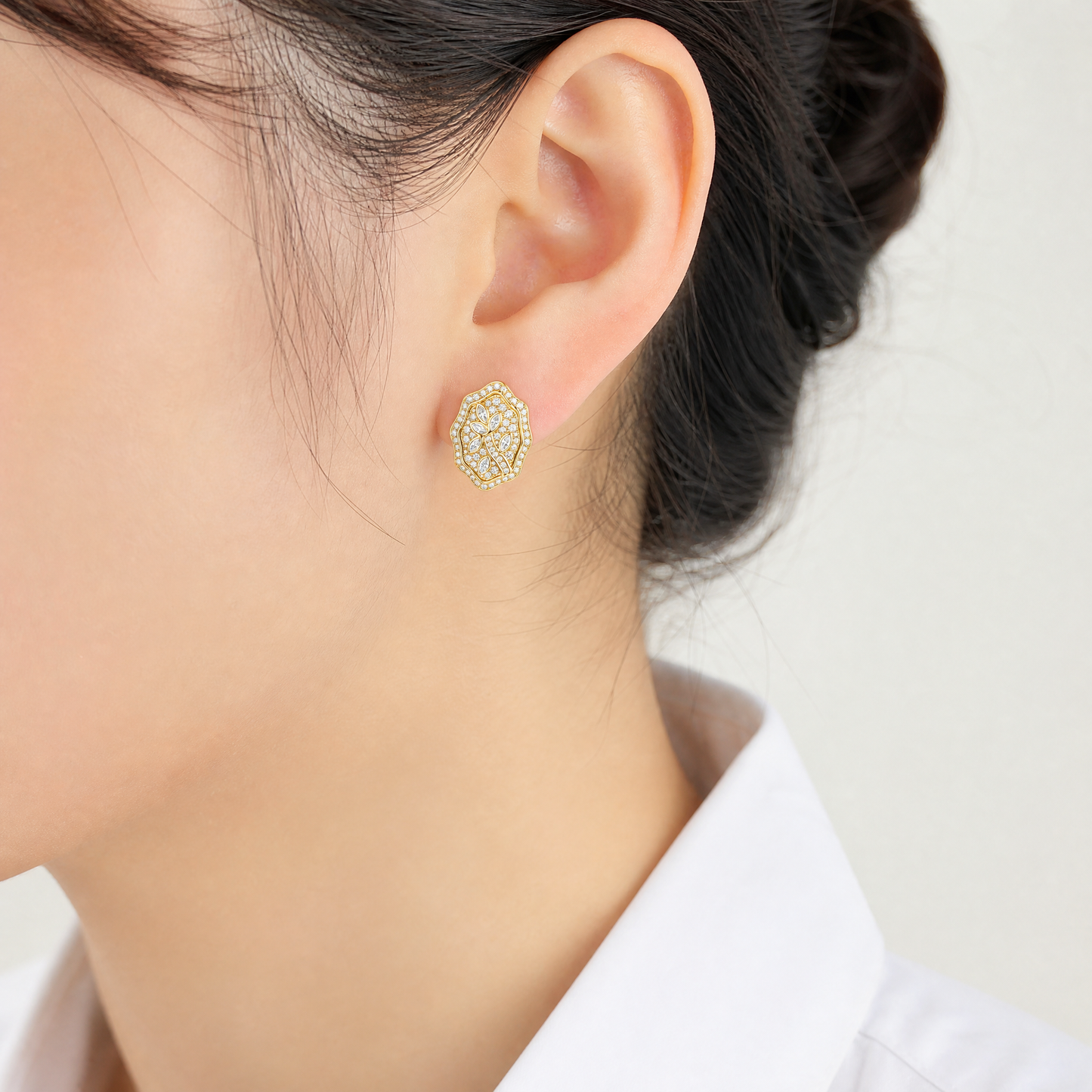 CAR3690 model shot - marquise and round diamond floral shield clip earring worn on ear