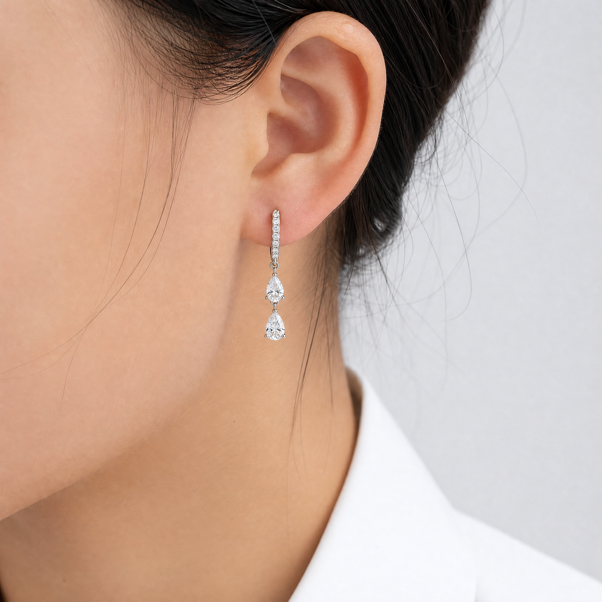 DECA1599W model shot - pear diamond pave huggie hoop drop earring worn on ear