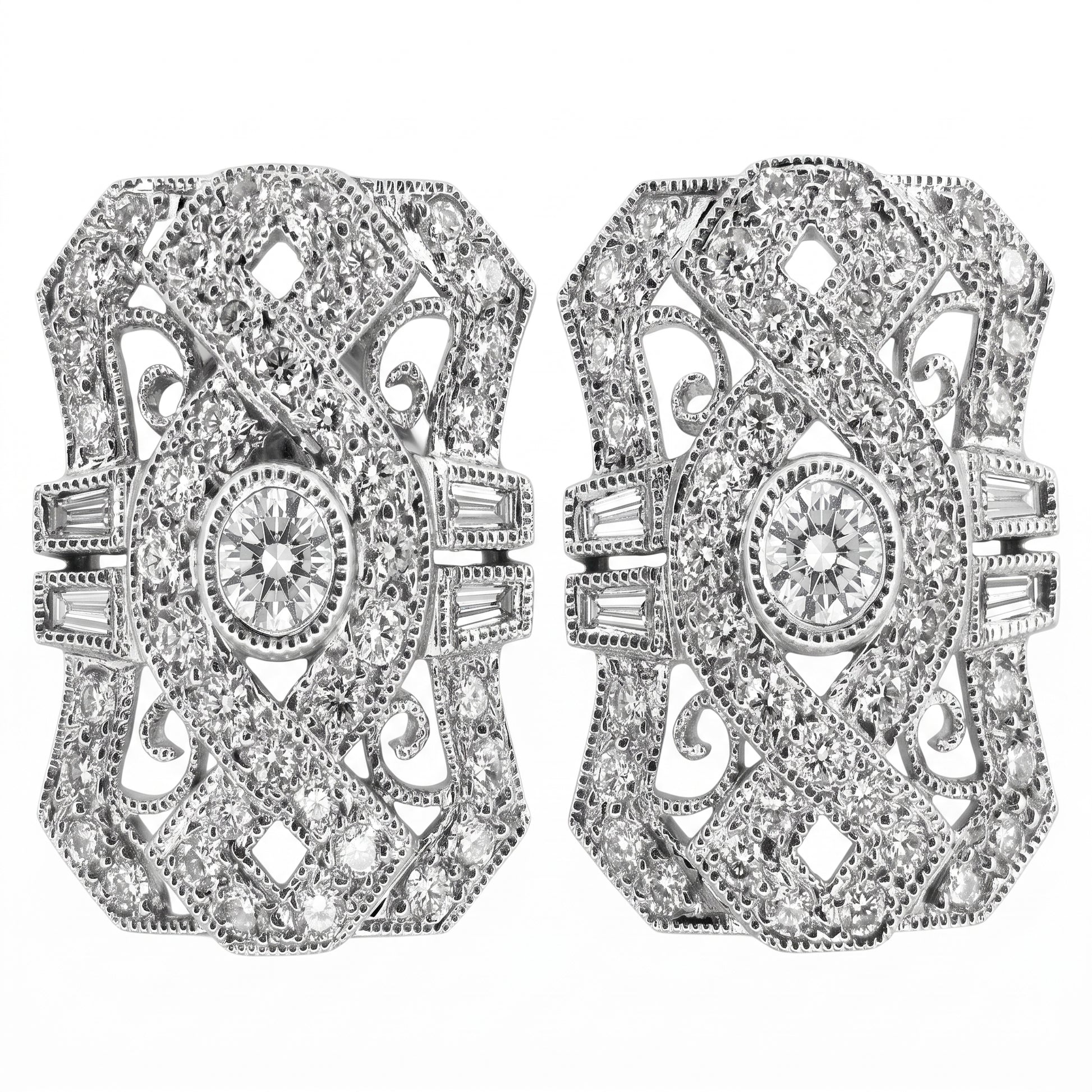 DECY0280W W-1 frontal pair - Art Deco shield-shaped filigree clip earrings with pinched concave sides and milgrain edging, a round brilliant centre diamond in a milgrain bezel collet, four tapered baguettes per earring set two either side of the waist, and pave round diamonds across pierced C-scroll filigree, in 18K white gold