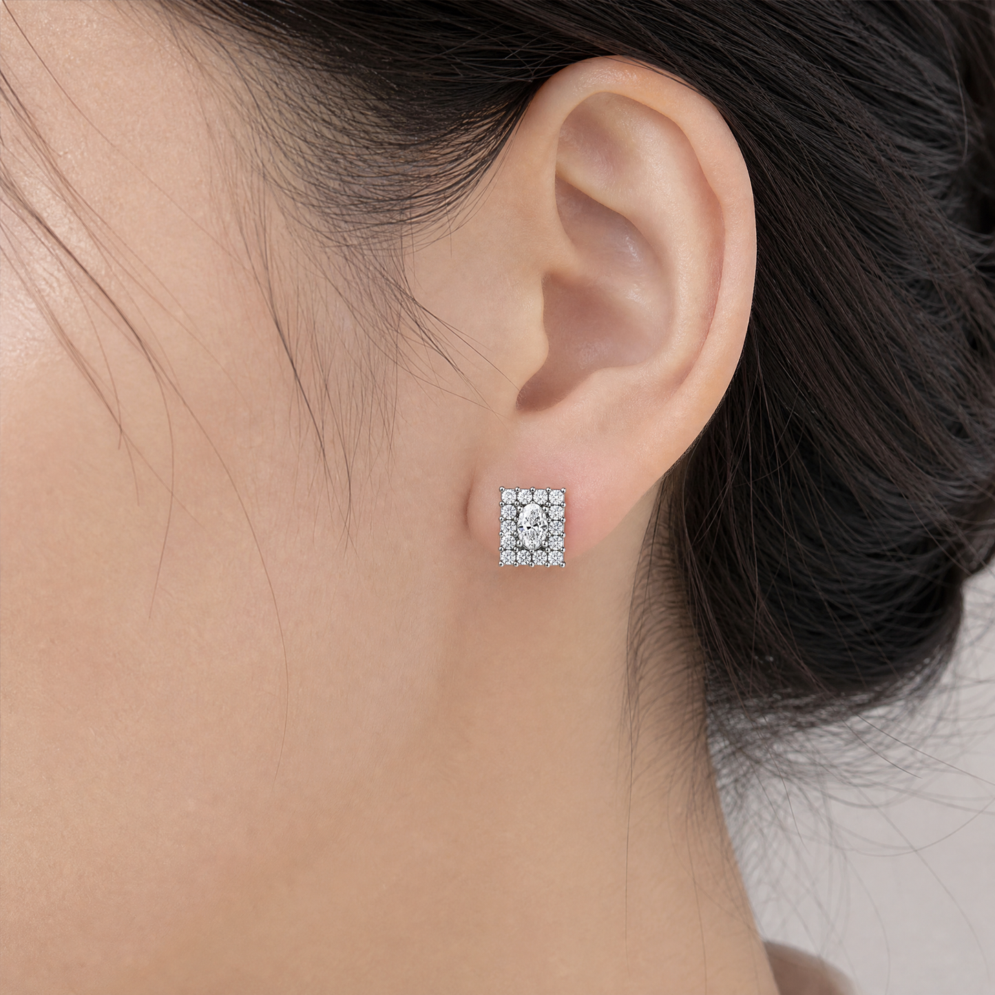 DECY0695W model shot - oval and princess-cut diamond rectangular cluster stud earring worn on ear