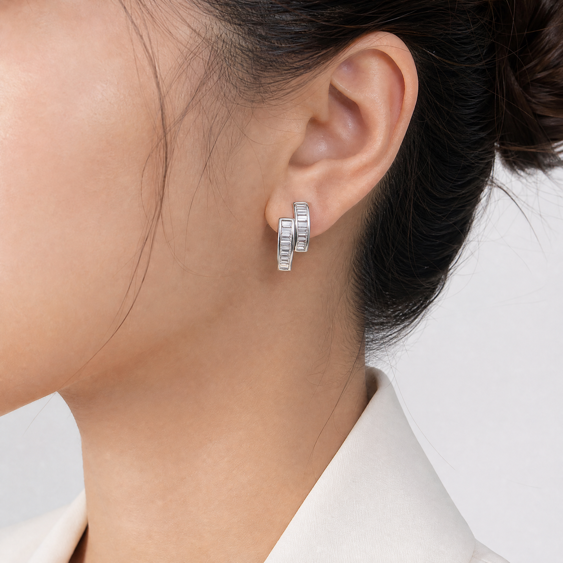 DEDY0088W model shot - tapered baguette diamond double-channel clip earring worn on ear