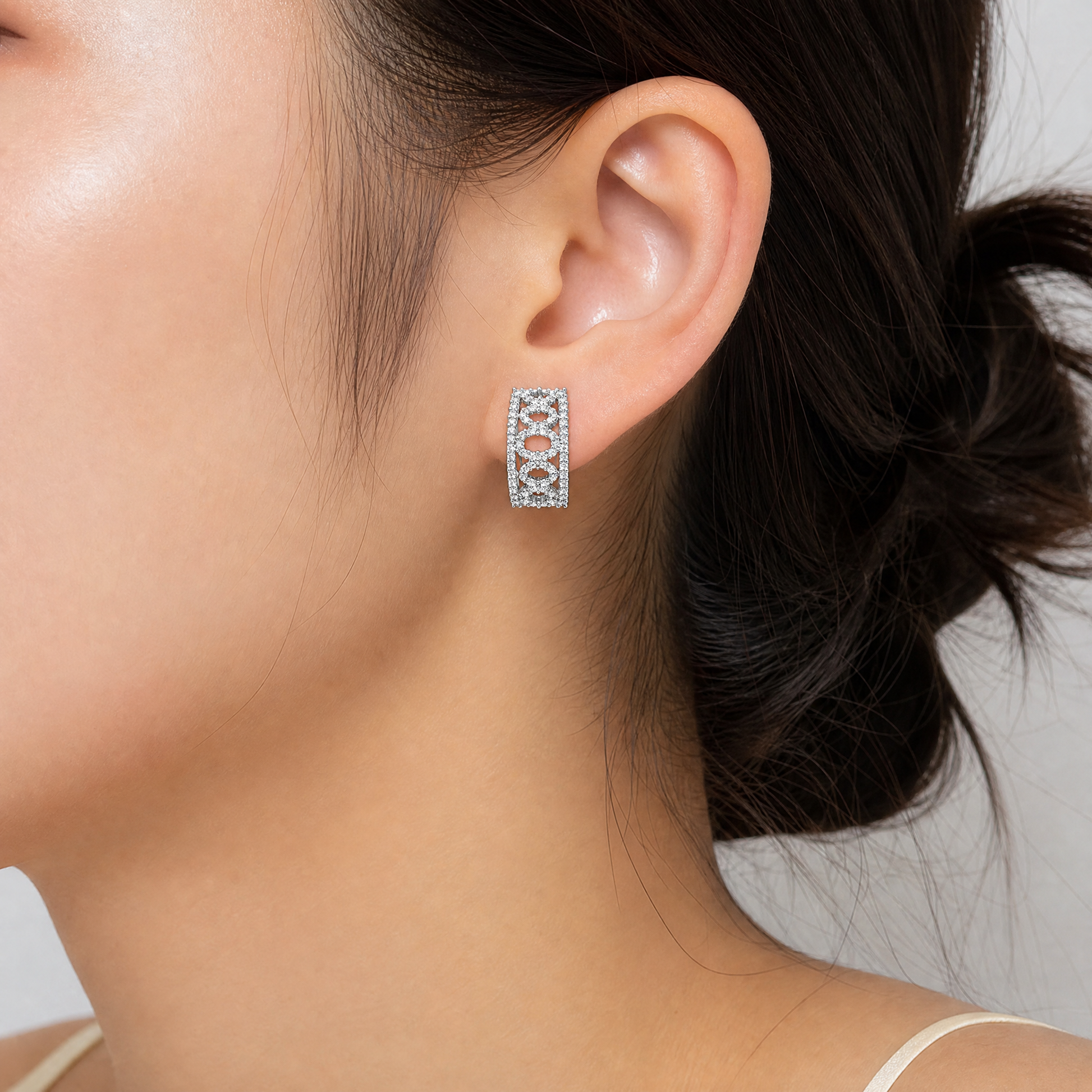 DEFT0318W model shot - wide diamond geometric lattice clip earring worn on ear