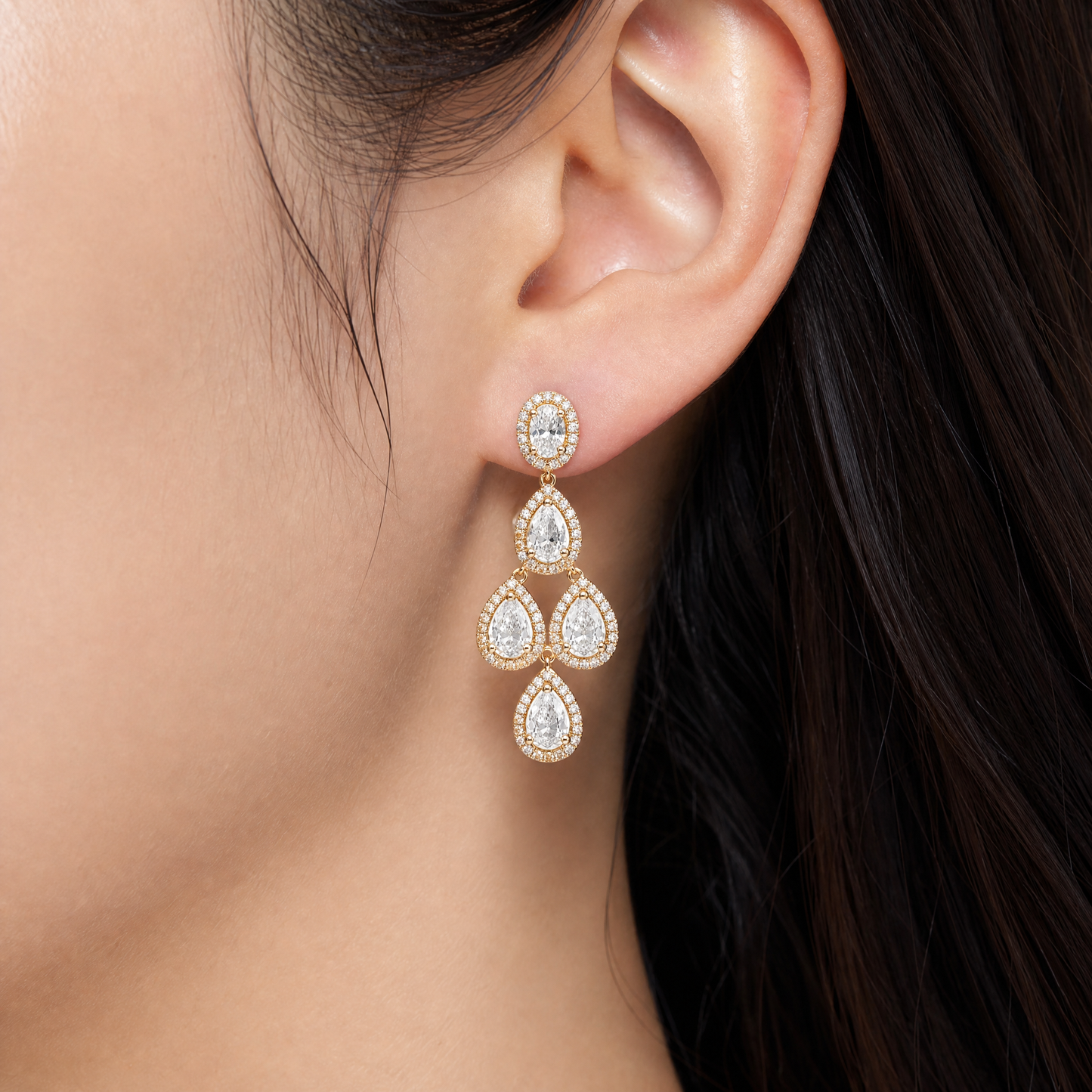 DEJA0004 model shot - pear and oval diamond four-tier chandelier earring worn on ear