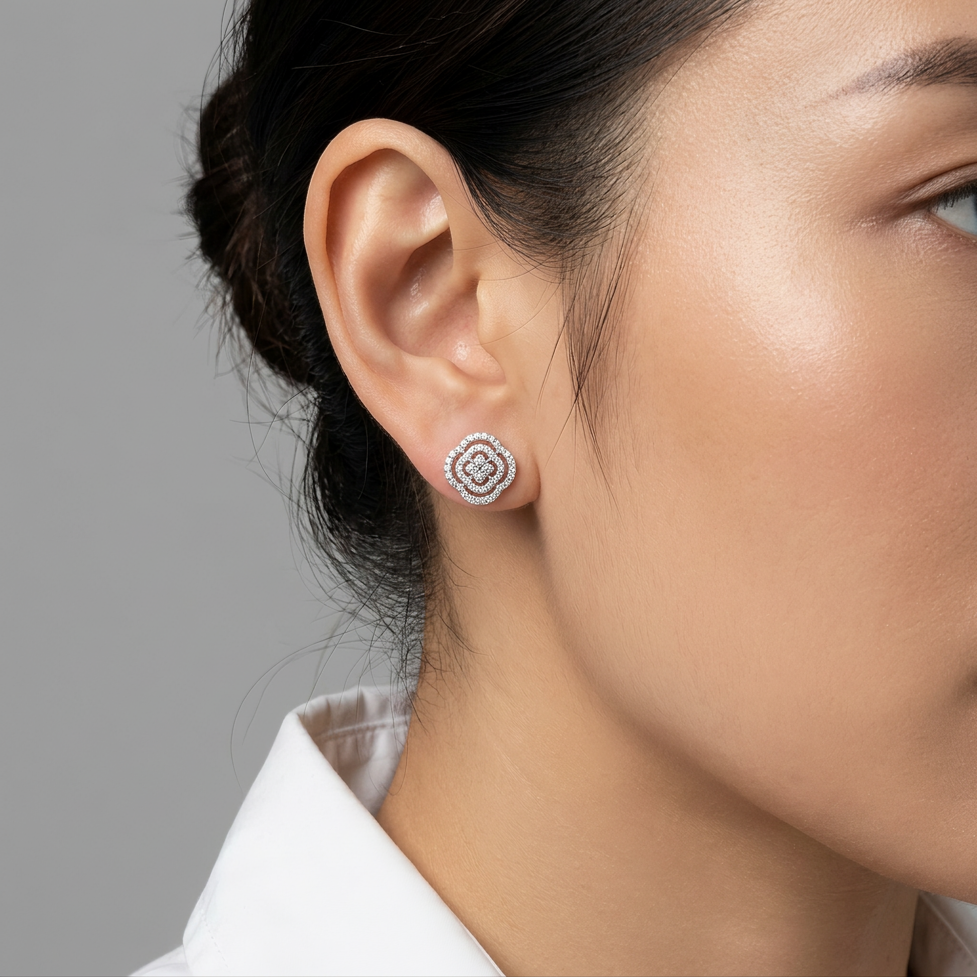 88-Diamond Flower Stud Earrings, 13mm - worn on the ear, showing the 18K white gold layered camellia rose flower stud sitting flush against the earlobe