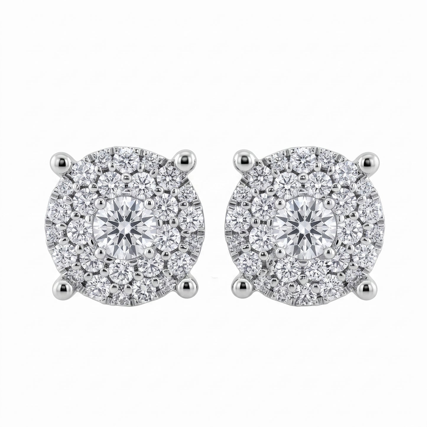 56-Diamond Round Stud Earrings, 7.5mm - 18K white gold round paved illusion cluster with one centre round brilliant, a ring of six medium round brilliants and outer rings of smaller round diamonds, four diagonal claw prongs
