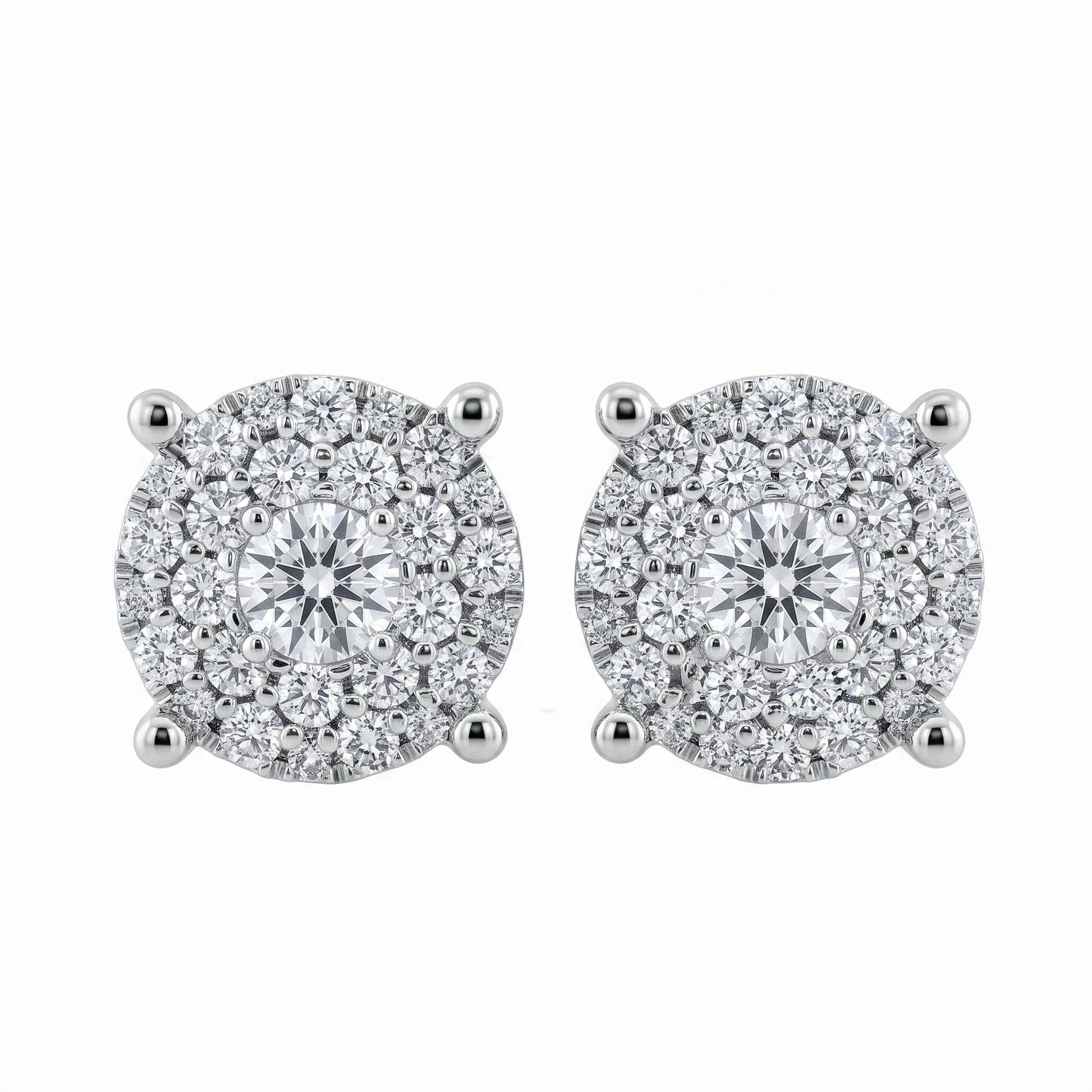 56-Diamond Round Stud Earrings, 7.5mm - 18K white gold round paved illusion cluster with one centre round brilliant, a ring of six medium round brilliants and outer rings of smaller round diamonds, four diagonal claw prongs