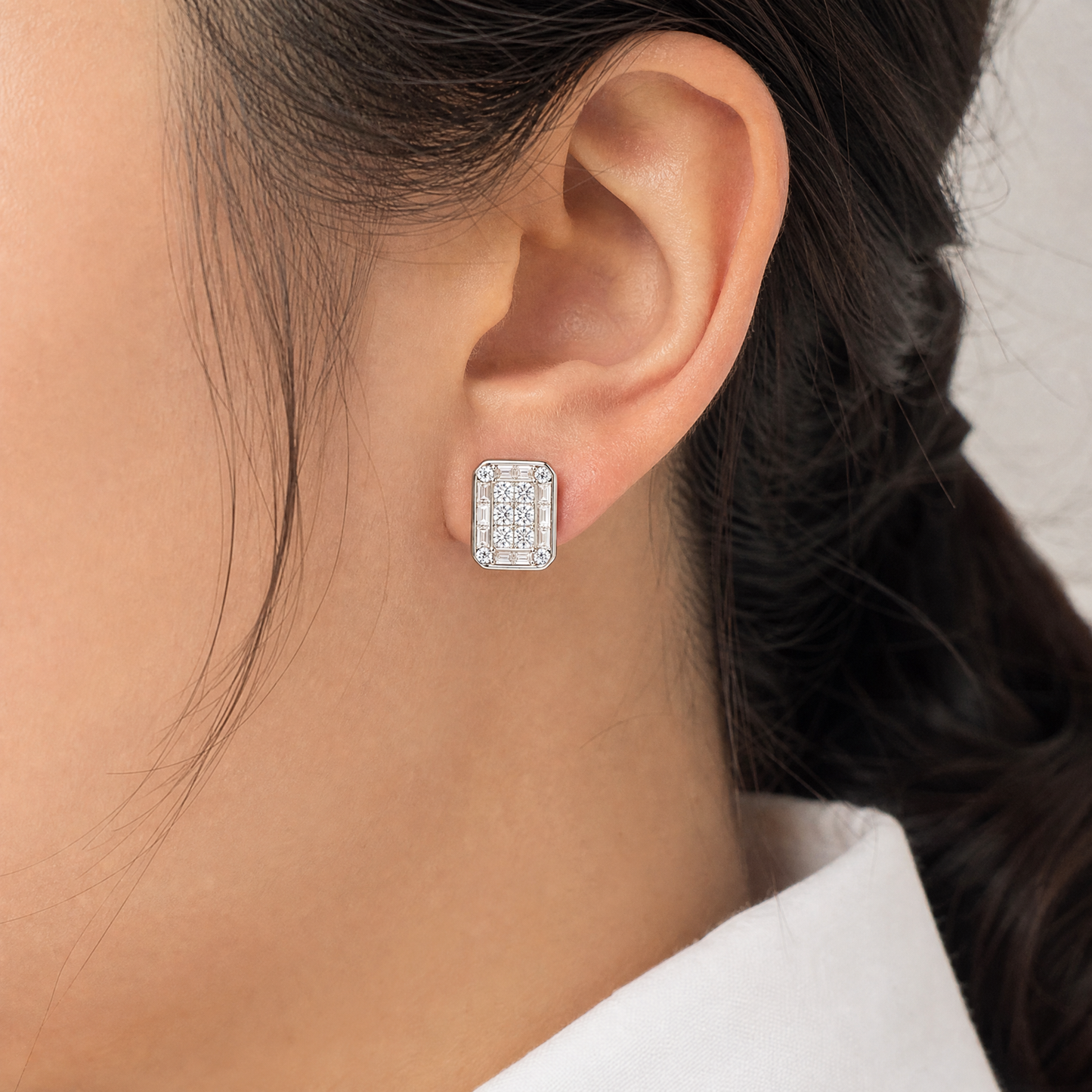 DERT0411W model shot - invisible-set princess and baguette diamond octagonal clip earring worn on ear