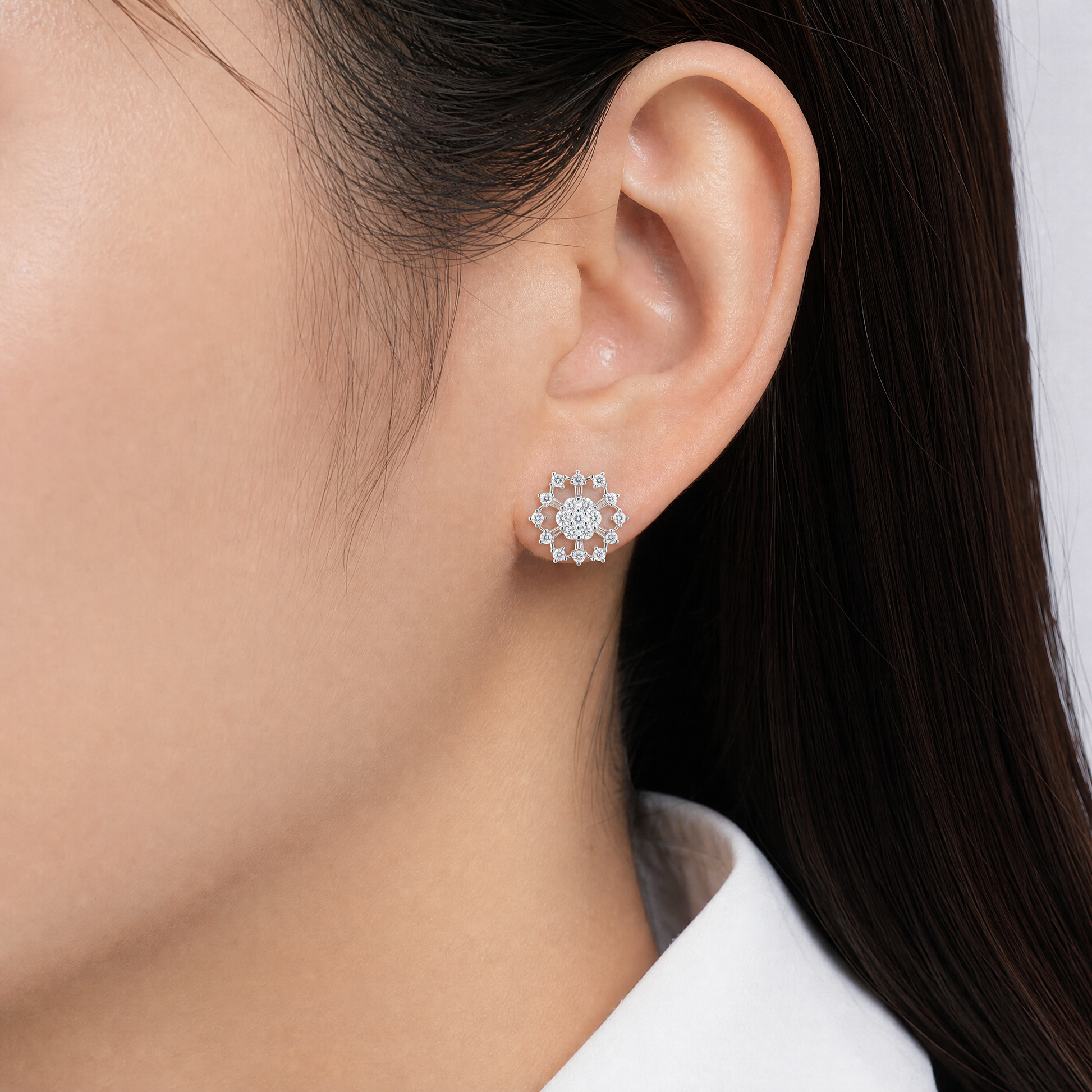 DERT0474W model shot - tapered baguette and round diamond openwork snowflake stud earring worn on ear