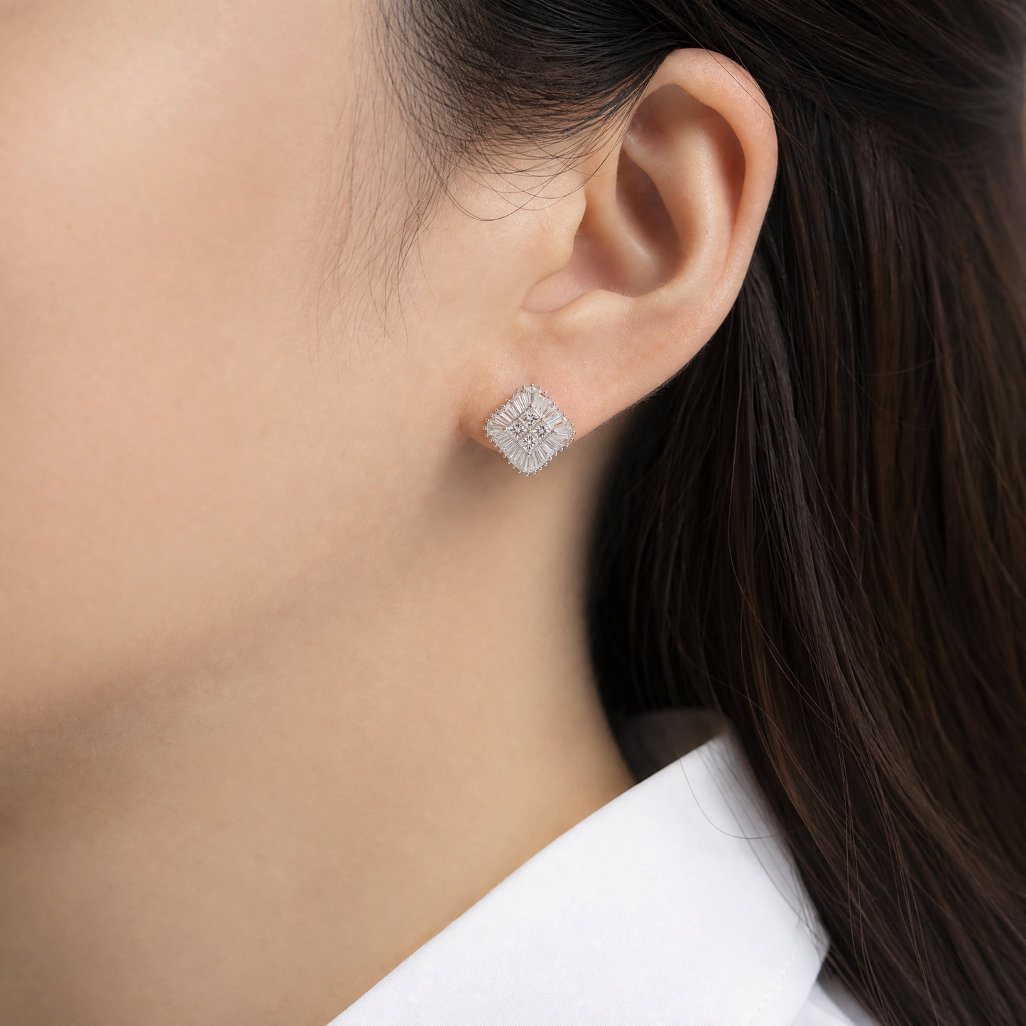 DERT0494W model shot - princess and tapered baguette diamond pinwheel clip earring worn on ear