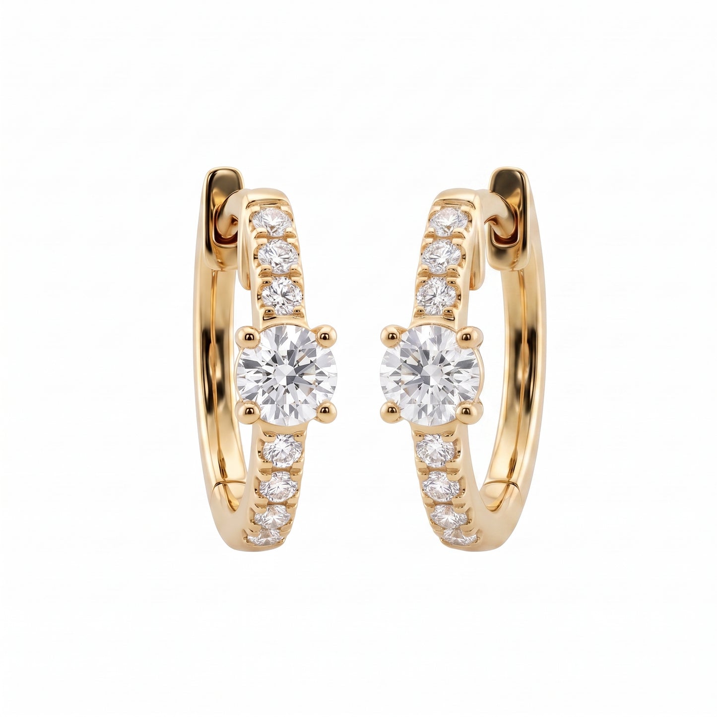 DERT0954 14K yellow gold hinged huggie hoop earrings with round brilliant centre stone and seven-diamond graduated row, angled view