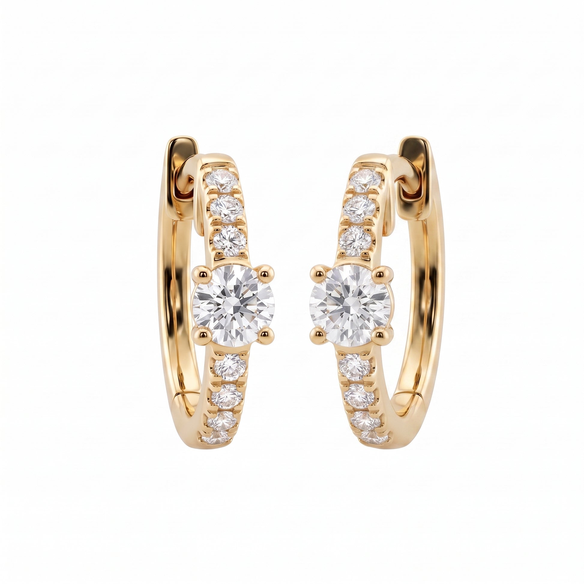 DERT0954 14K yellow gold hinged huggie hoop earrings with round brilliant centre stone and seven-diamond graduated row, angled view