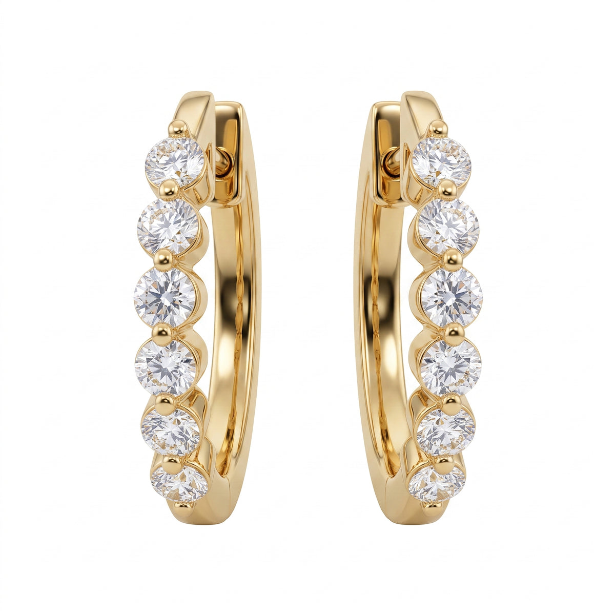 18k yellow gold oval huggie hoop earrings with six round brilliant diamonds each, white background