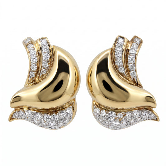 DESL0024 W-1 frontal pair - sculptural asymmetric swirl clip earrings in 18K yellow gold, a high-polish mirror-finish plain gold body curling through the centre with a ribbon of two channel-set rows of round diamonds sweeping up one side and a triangular pave wedge along the bottom