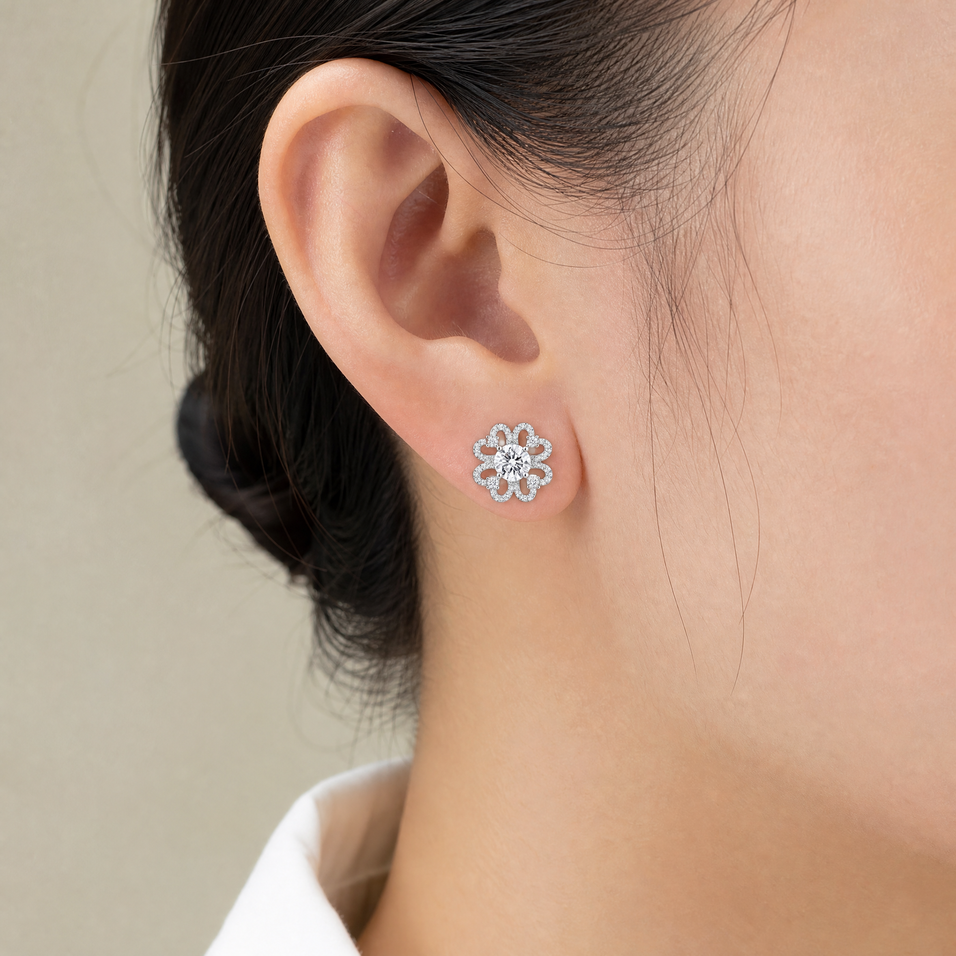 DETE0518W model shot - openwork six-petal clover flower pave diamond stud earring worn on ear
