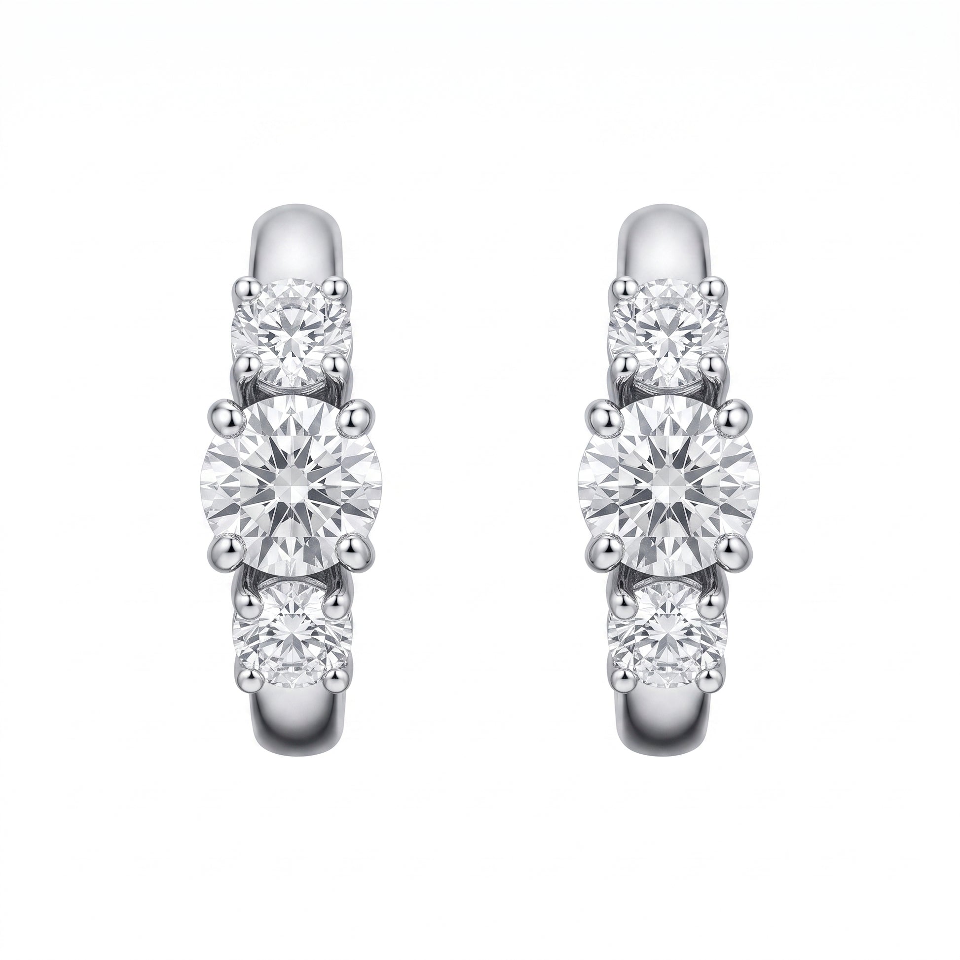 18k white gold three-stone graduated round diamond huggie hoop earrings, white background