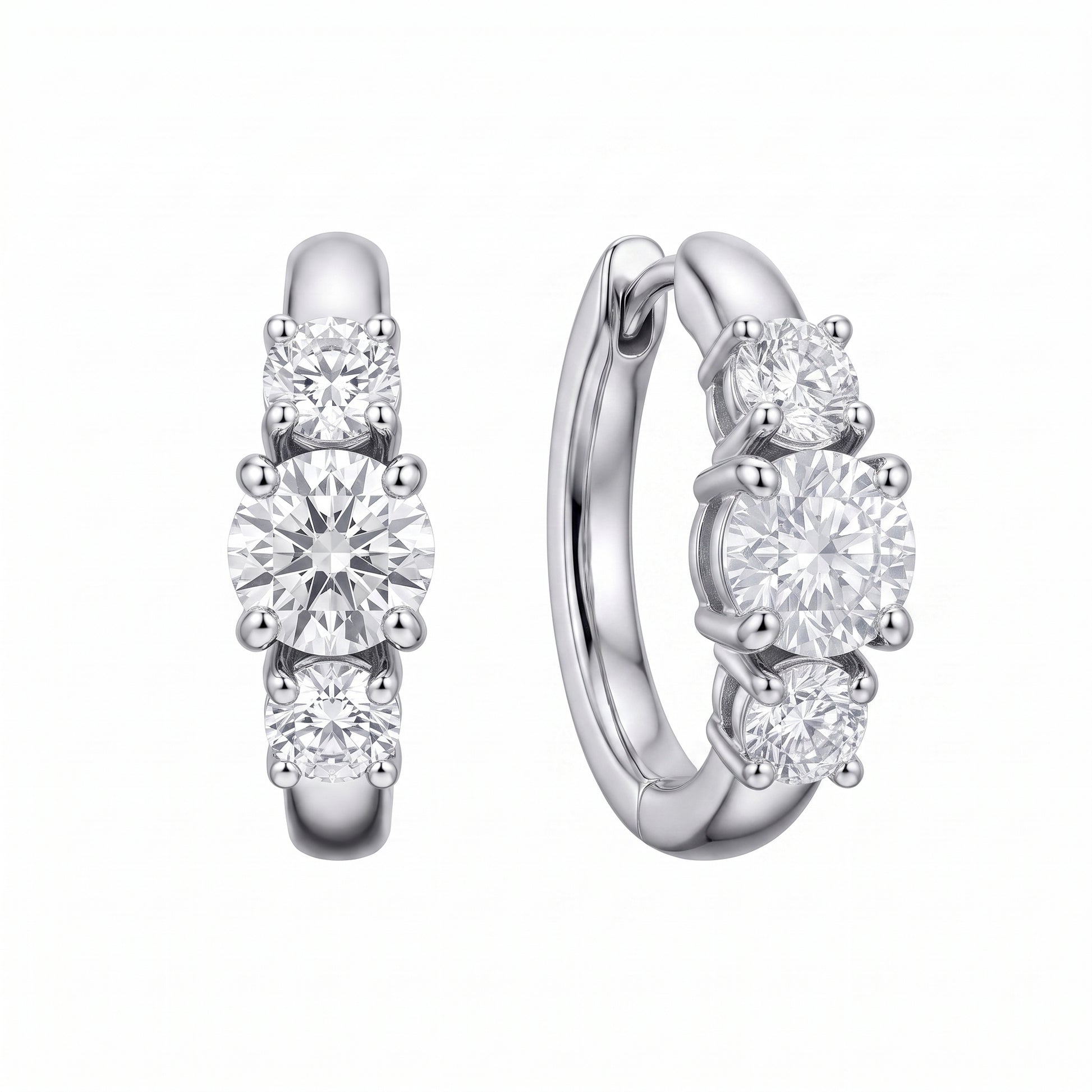 18k white gold three-stone graduated round diamond huggie hoop earrings, front and turned profile view showing the plain rear arc and hinged back, white background