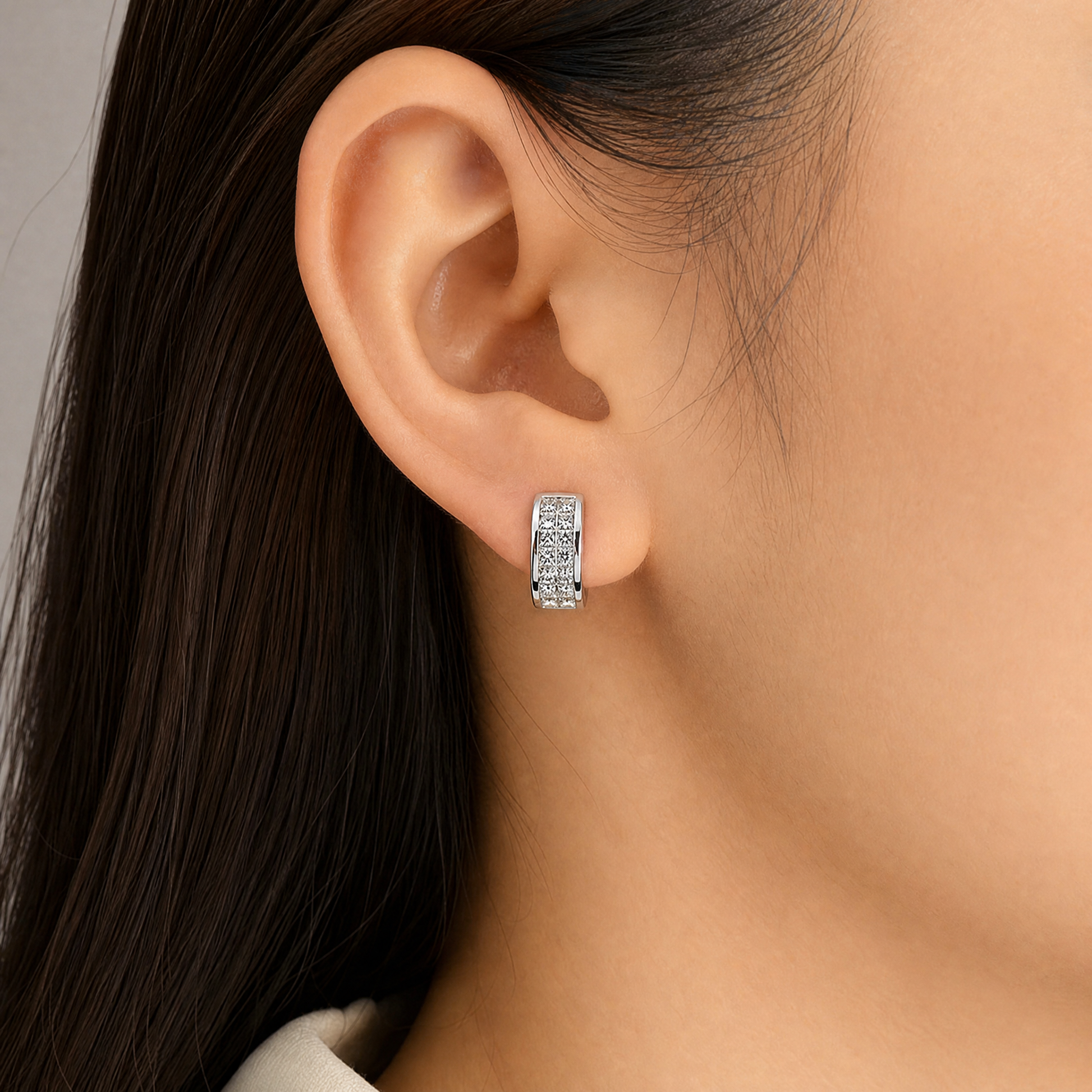 DEWA0028W model shot - invisible set princess-cut diamond three-row clip earring worn on ear
