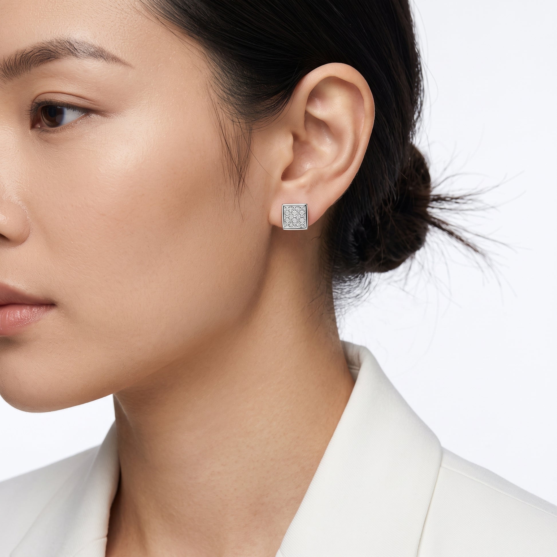 DEWA0262W M-1 worn on the ear - square nine-diamond invisible-set princess-cut plaque stud sitting flush on the lobe, 18K white gold
