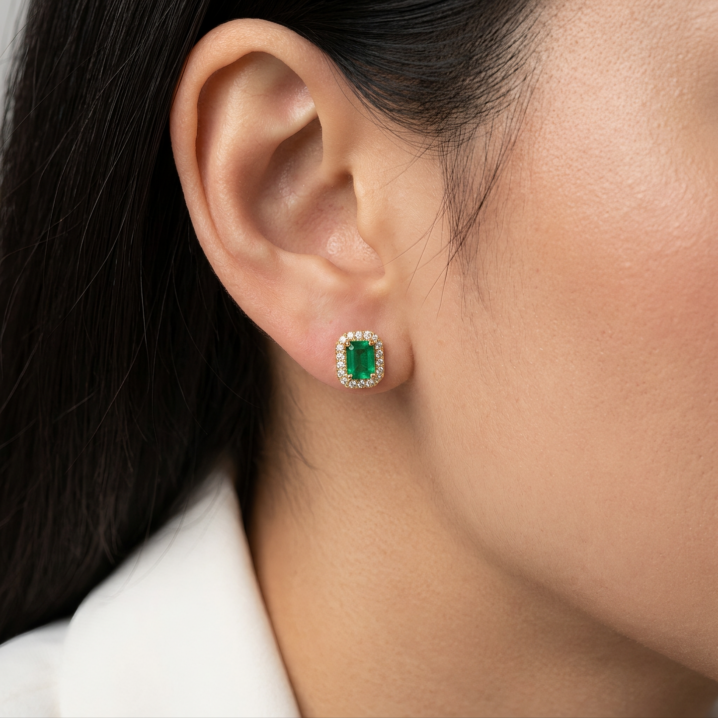 4x6mm Emerald-Cut Emerald & Diamond Halo Stud Earrings - model wearing the 14K yellow gold emerald and diamond halo stud on the earlobe