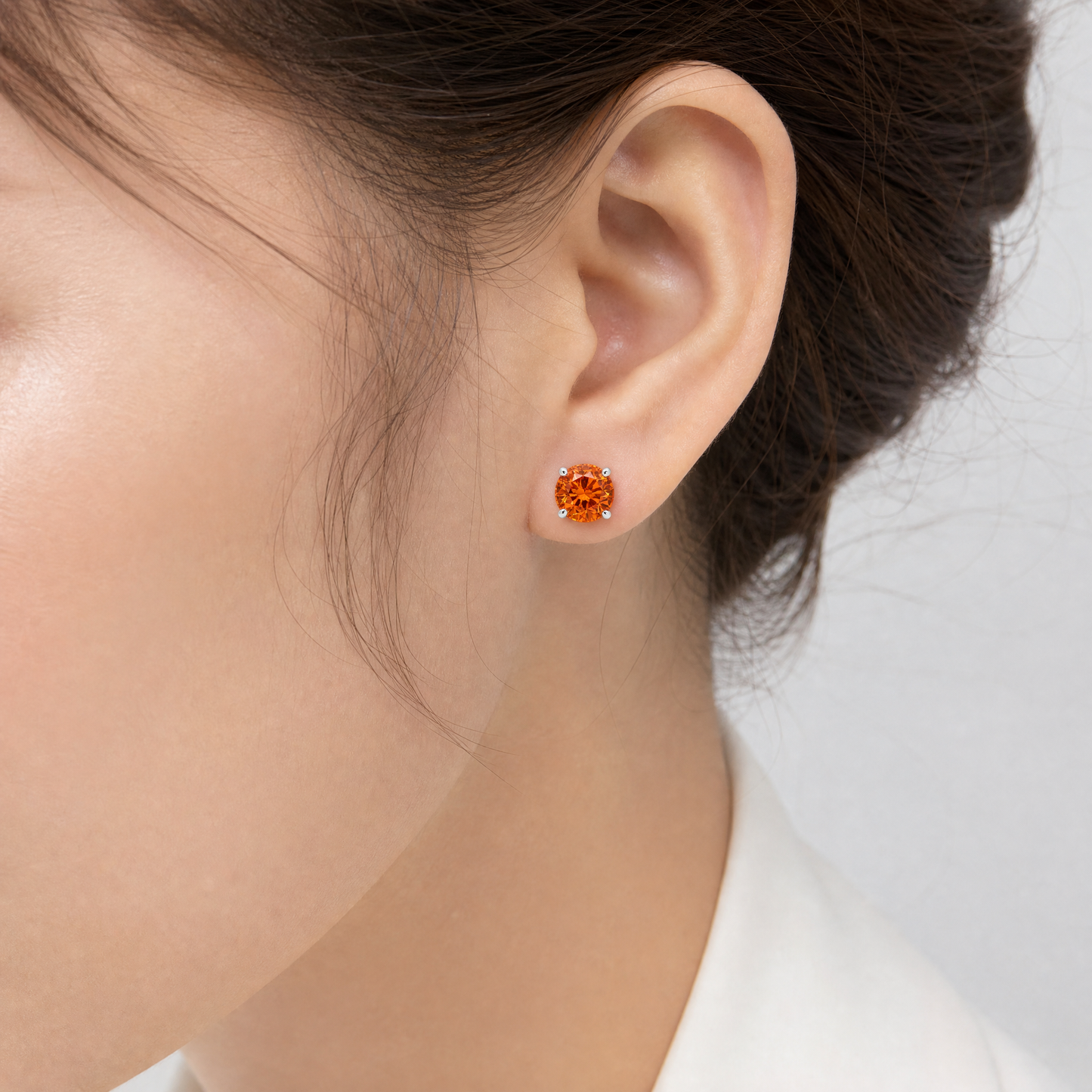 GECA0989W-SP model shot - round orange spessartite garnet solitaire stud earring in 14K white gold worn on ear