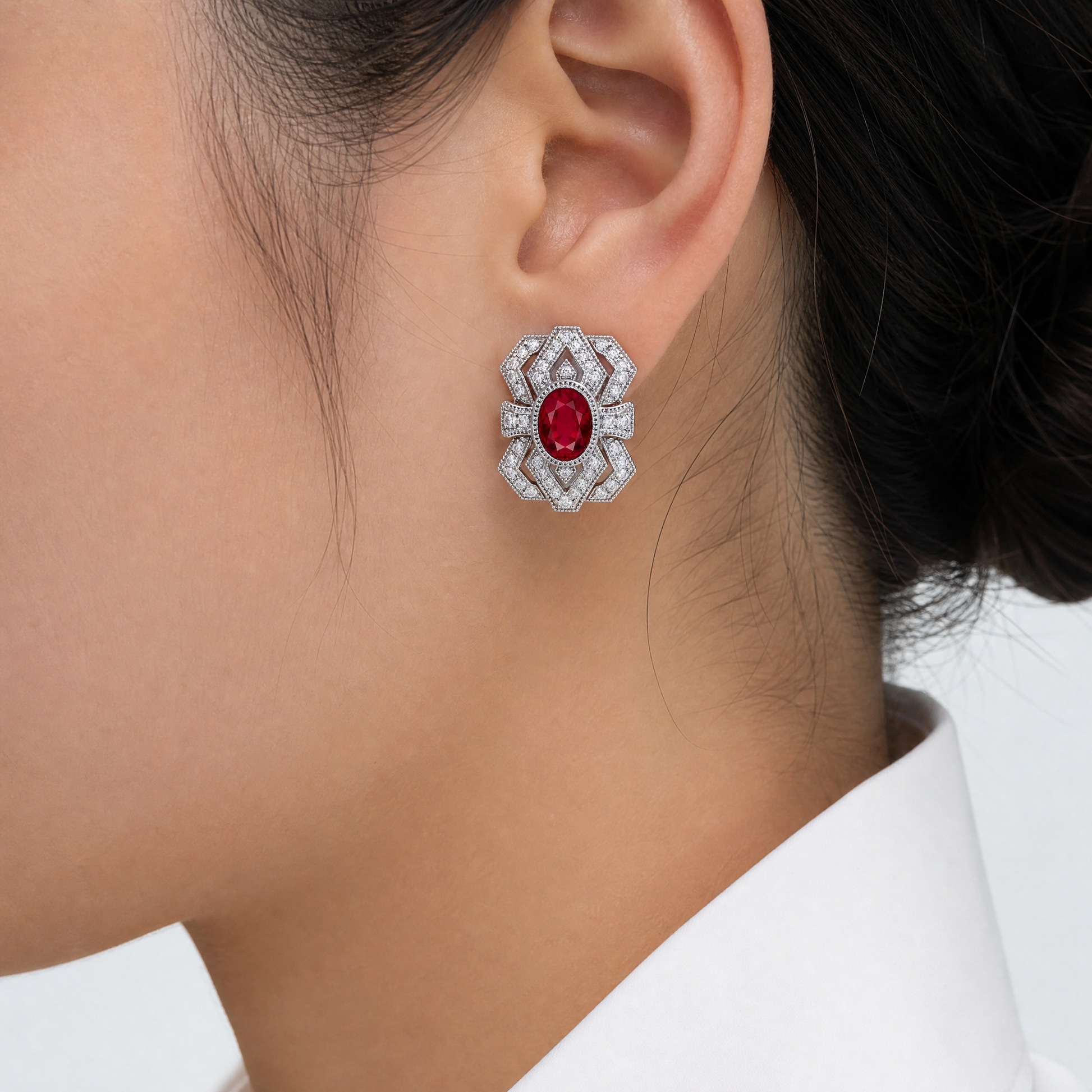 RECY0243W model shot - oval ruby and diamond Art Deco openwork filigree clip earring worn on ear