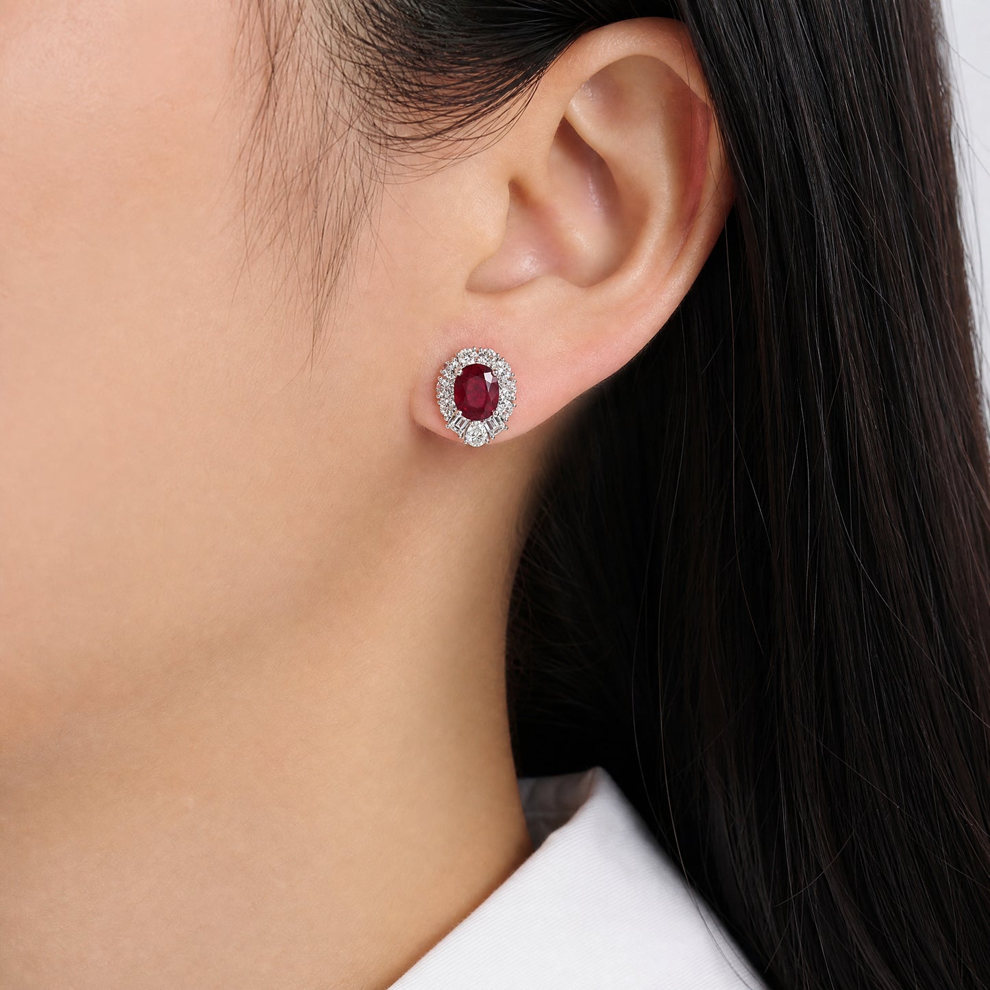 RECY0524W M-1 model wearing oval ruby and diamond halo clip earrings in 18K white gold