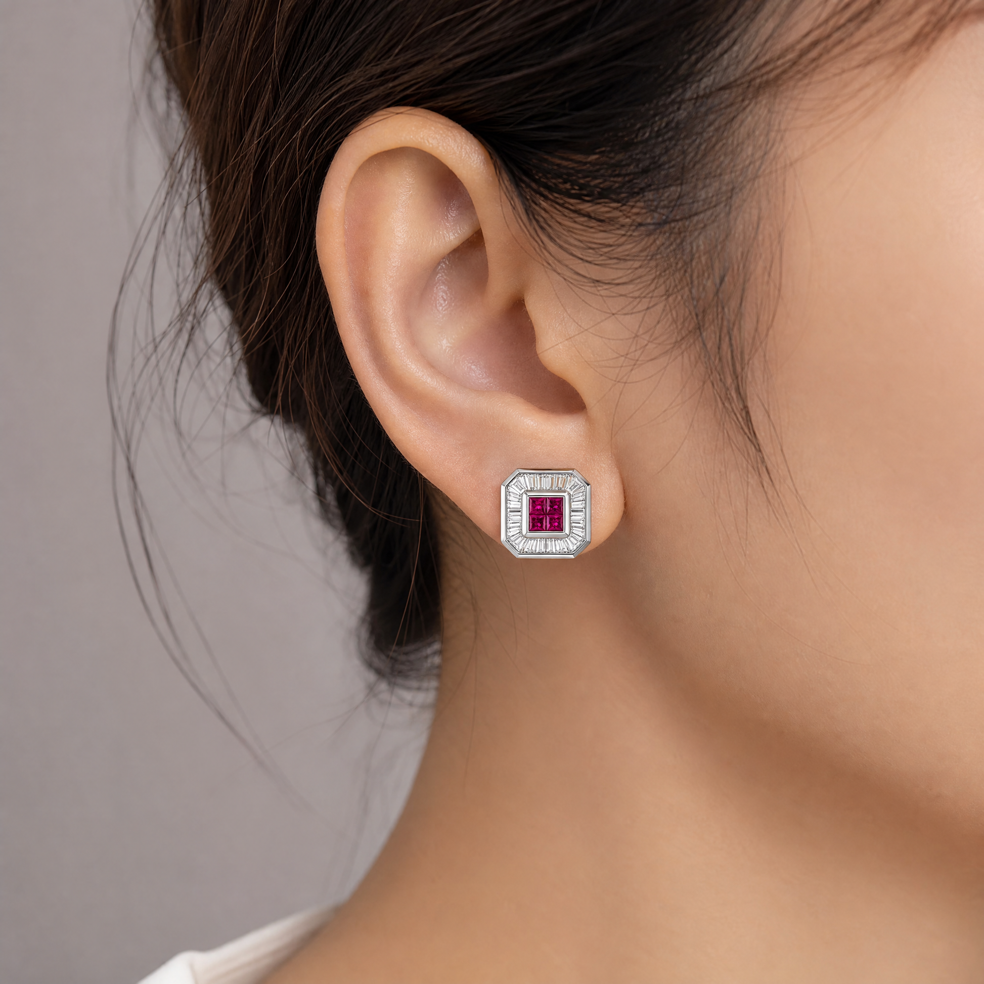 RERT0433W model shot - invisible-set ruby and tapered baguette diamond clip earring worn on ear