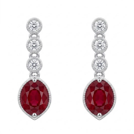 Oval ruby and bezel-set diamond drop earrings in 14K white gold, front view on white