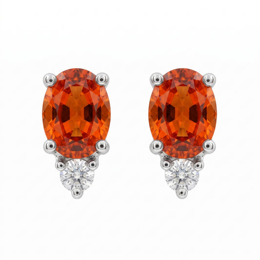 14k white gold oval orange-red sapphire and round diamond post earrings, white background