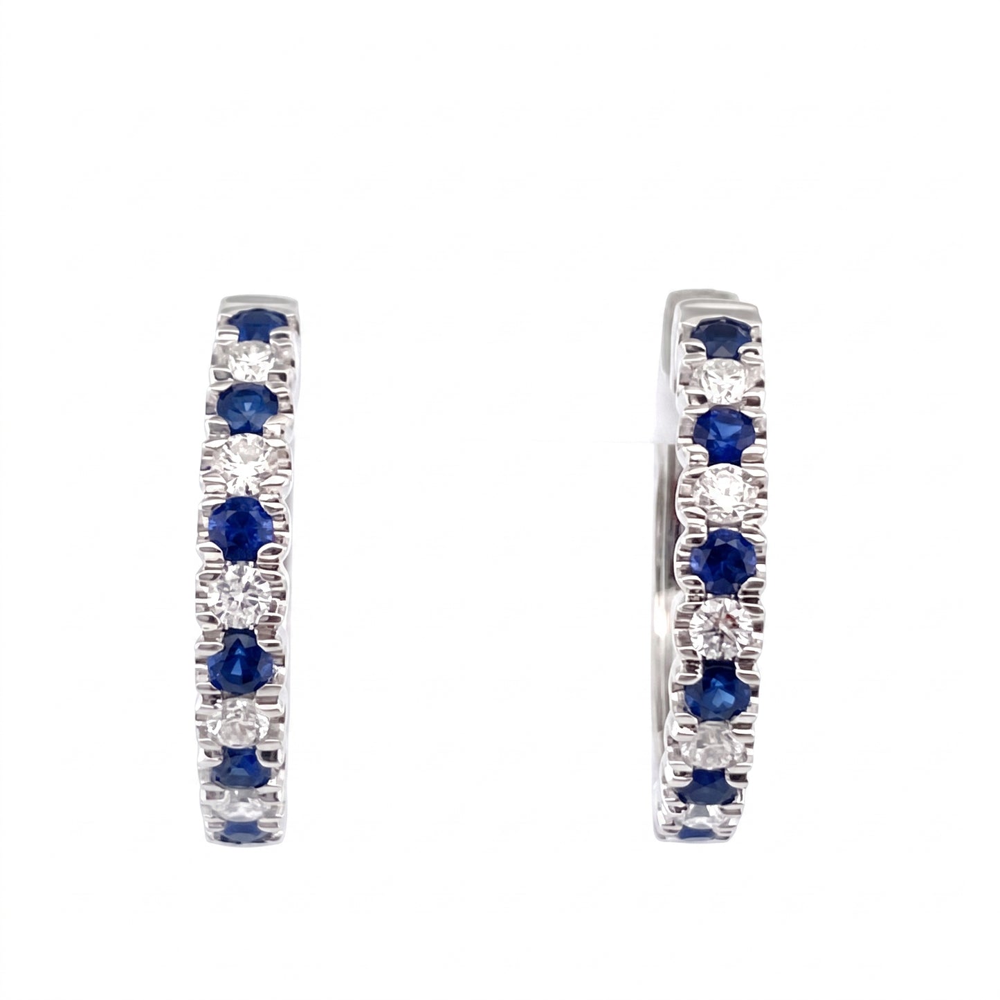 18K white gold hoop earrings with alternating blue sapphires and diamonds on a white background