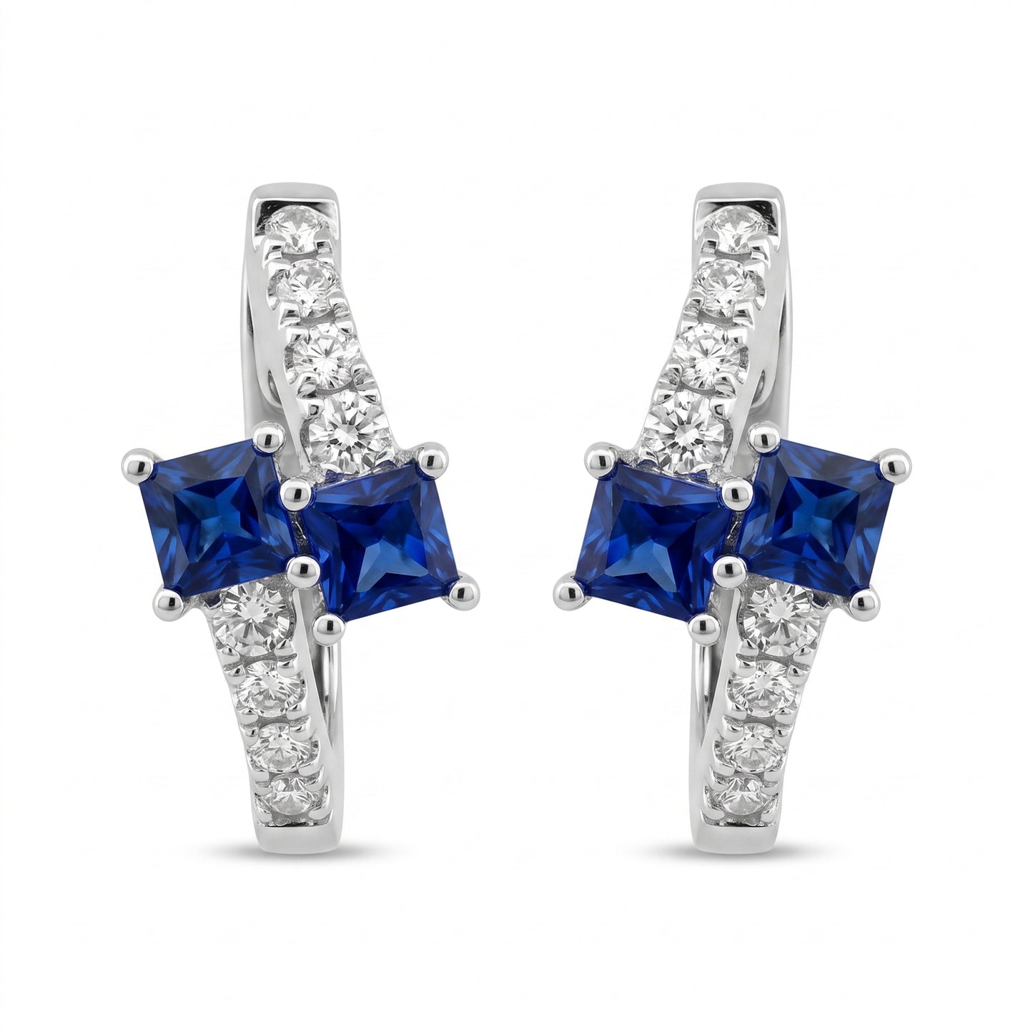 SEGS1005W 18K white gold oval huggie hoop earrings with two princess-cut blue sapphires and eight round diamonds each, white background