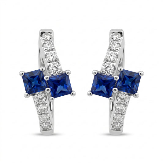 SEGS1005W 18K white gold oval huggie hoop earrings with two princess-cut blue sapphires and eight round diamonds each, white background