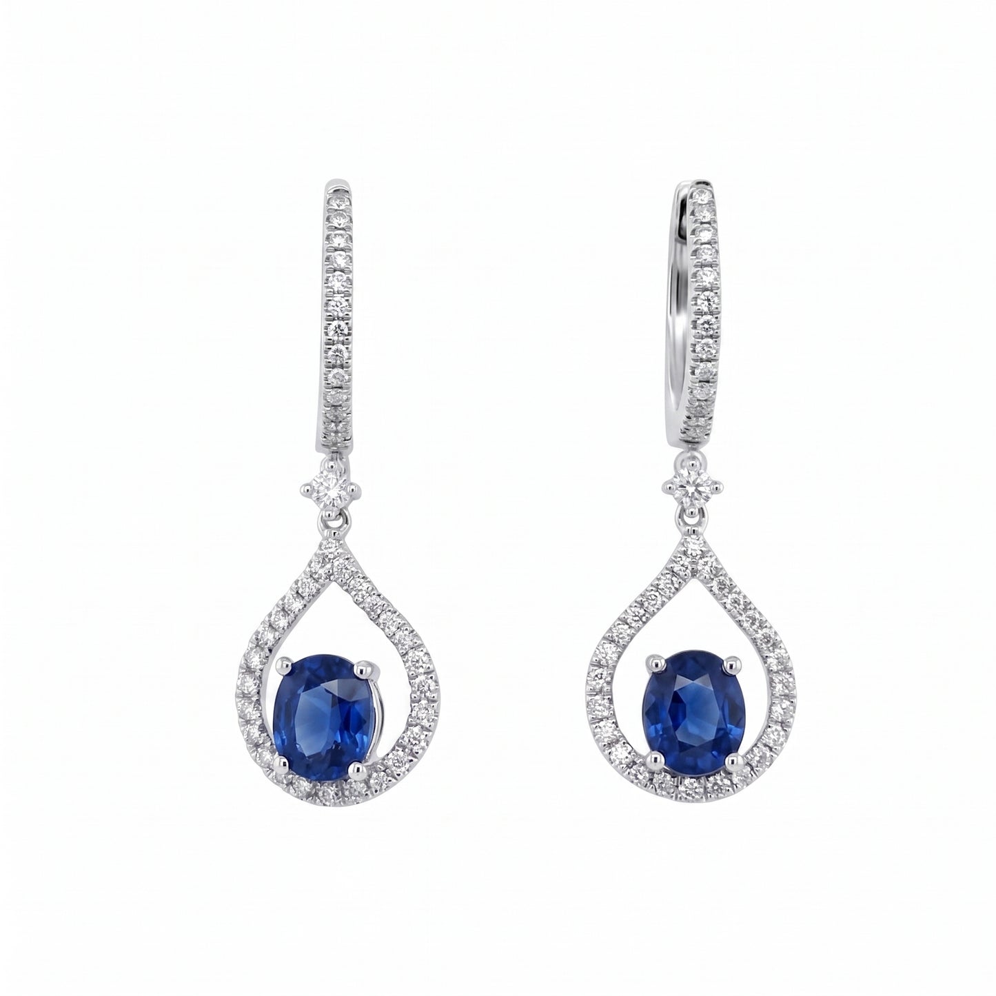 14K white gold oval blue sapphire and diamond open teardrop drop earrings on a white background