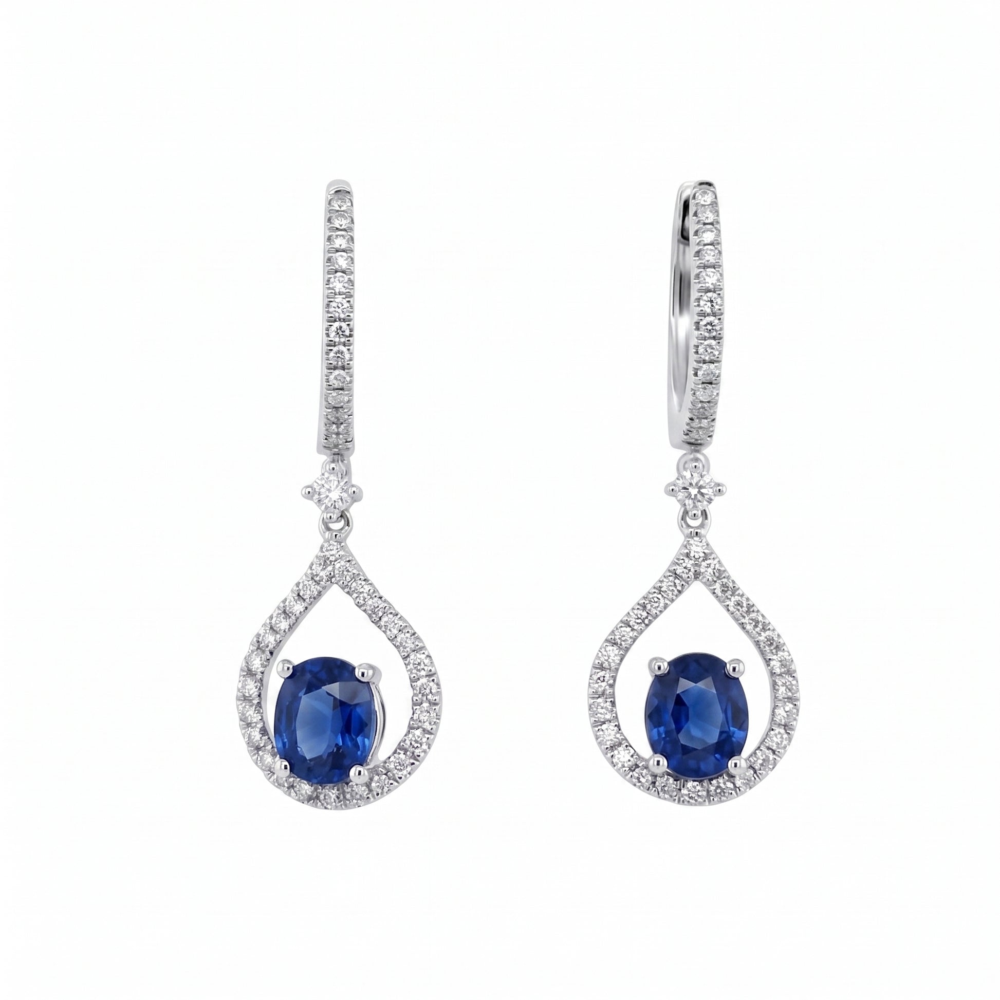 14K white gold oval blue sapphire and diamond open teardrop drop earrings on a white background