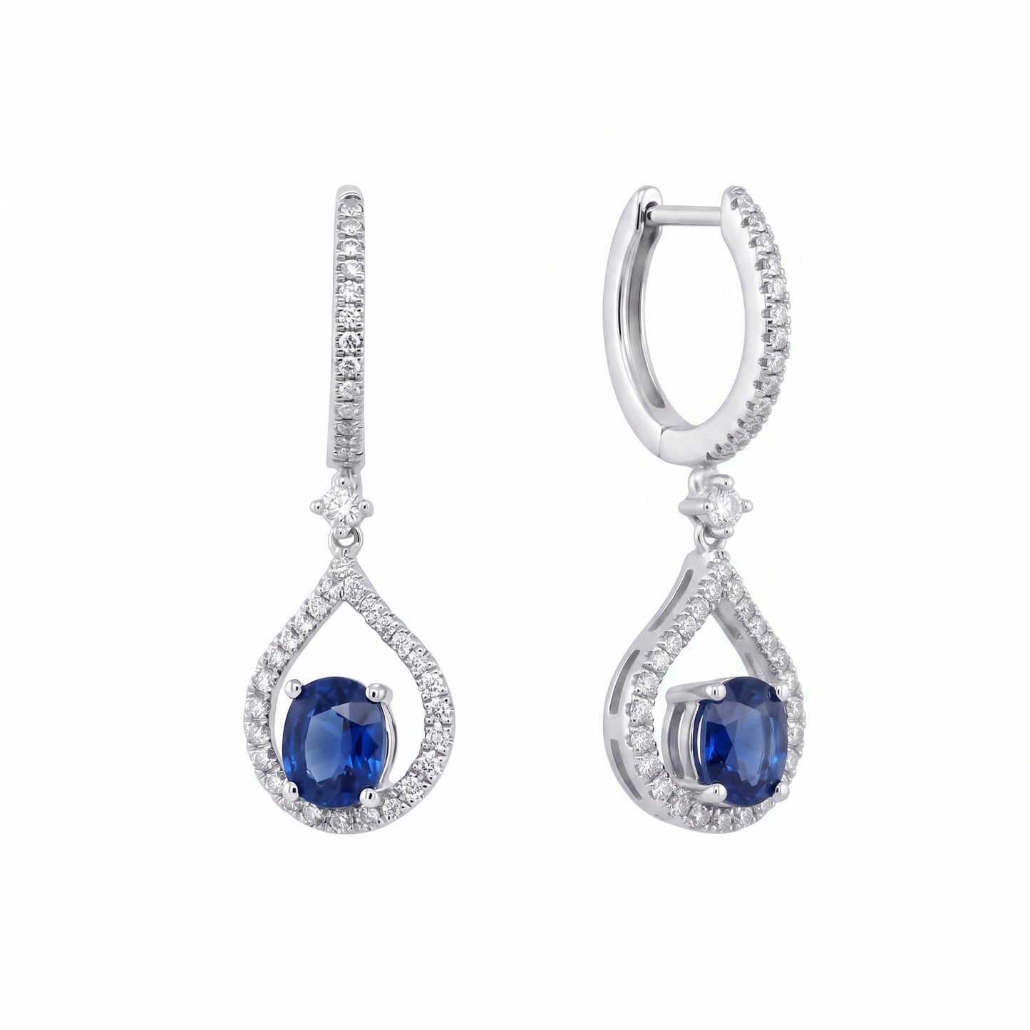 14K white gold oval blue sapphire and diamond teardrop drop earrings, angled view showing the hinged pave hoop and plain inner band, on a white background