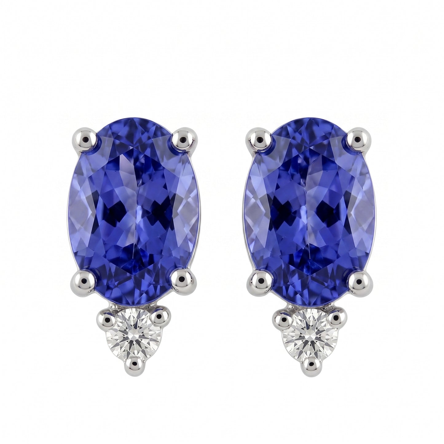 14k white gold seven by five millimetre oval tanzanite and round diamond post earrings, white background