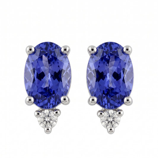 14k white gold seven by five millimetre oval tanzanite and round diamond post earrings, white background